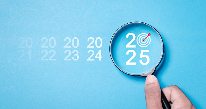 Magnifying glass hovering over the year 2025