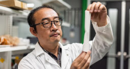 Dr. Li of University of Texas Dallas holding a 3D printed femur