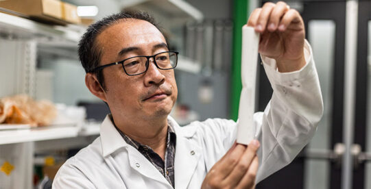 Dr. Li of University of Texas Dallas holding a 3D printed femur