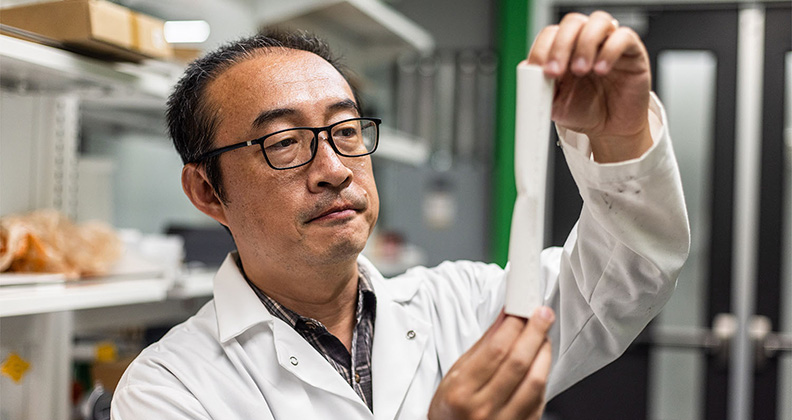 Dr. Li of University of Texas Dallas holding a 3D printed femur