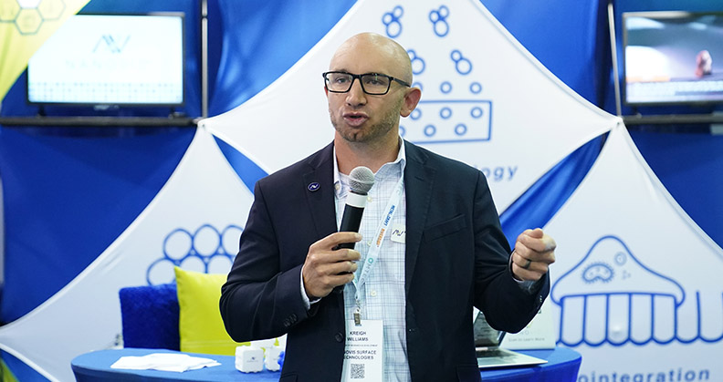 Kreigh Williams of Nanovis speaking at the company's OMTEC booth