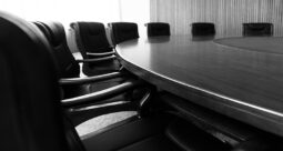 Empty seats around a round boardroom table