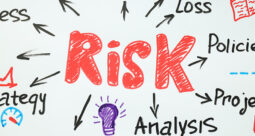 Risk in red lettering on a white background with arrows pointing to project management words in a collage