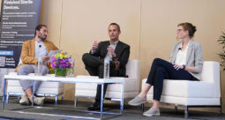 Panelists sitting in white chairs at the AI-driven R&D panel discussion at OMTEC 2026