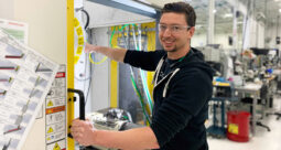 A smiling Autocam worker on the manufacturing floor
